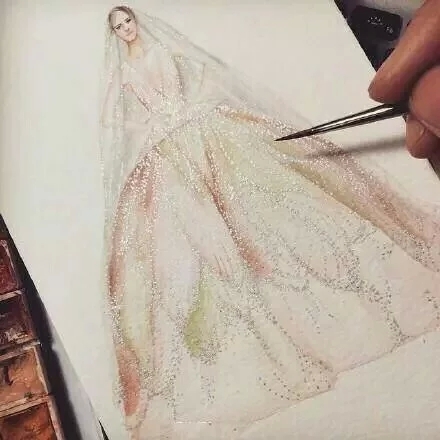 设计师手上的手绘婚纱图片