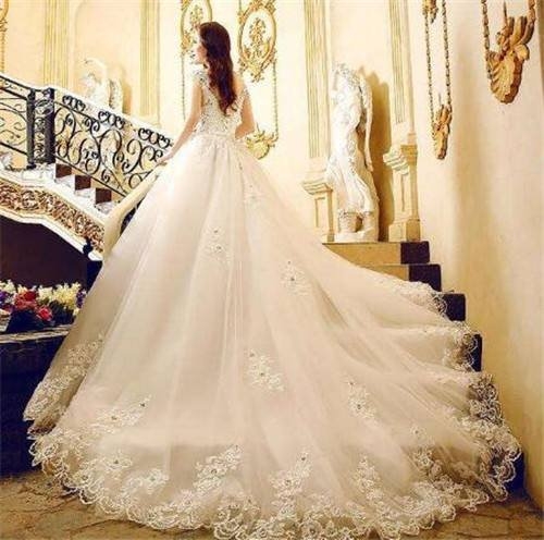 美丽新娘的浪漫白色露肩拖地婚纱长裙图片